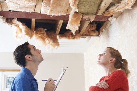 home repair: Builder And Client Inspecting Roof Damage