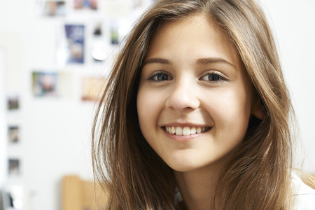 Portrait Of Smiling Teenage Girl At Home - 65619694