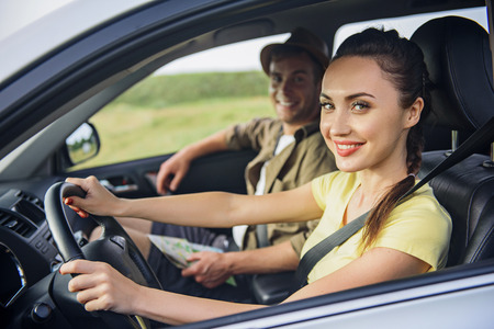 私たちは旅行が好きです 幸せな夫婦が車で座っていると笑顔します 女性が運転する喜びとカメラ目線 の写真素材 画像素材 Image