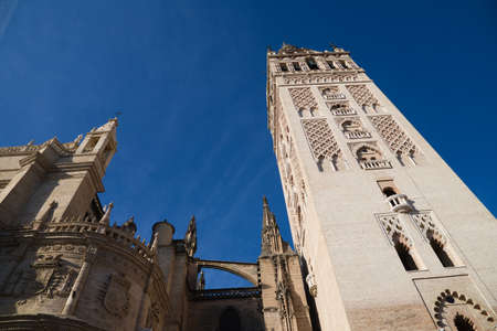 Gothic style cathedral in the city of seville in spain. you can see its bell tower known as the giralda. it is the largest catholic religious building in the world. tourism and travel concept. Banco de Imagens