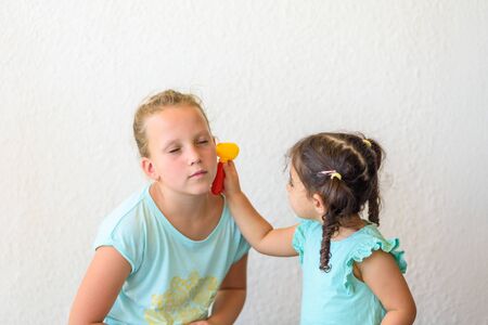 children playing doctor little doctor examining patients ear children play doctor