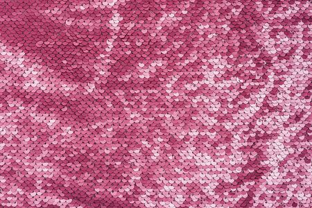 Pink purple shiny fabric with sequins, abstract background. close-up.