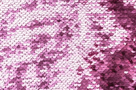 Pink purple shiny fabric with sequins, abstract background. close-up. Stock Photo