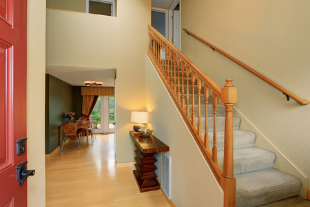Entrance Hallway In Ivory Tones With View Of Staircase And Dining Table Set Has Light Entrance Hallway In Ivory Tones With View Of Staircase And Dining Table Set Has Light