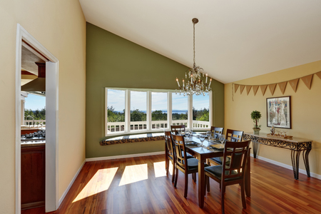 Elegant Dining Room With Contrast Olive Wall Vaulted Ceiling Comfortable Window Seat And Hardwood Elegant Dining Room With Contrast Olive Wall Vaulted Ceiling Comfortable Window Seat And Hardwood