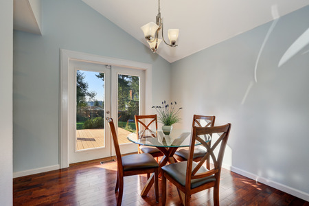 Pastel Blue Walls And Vaulted Ceiling Of American Dining Room Furnished With Glass Top Wooden Pastel Blue Walls And Vaulted Ceiling Of American Dining Room Furnished With Glass Top Wooden