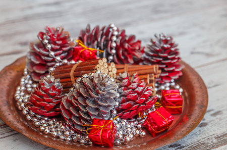 christmas decorations of colored cones sticks beads on a copper tray on a light gray - Copper Christmas Decorations christmas decorations of colored cones sticks beads on a copper tray on a light gray - Copper Christmas Decorations