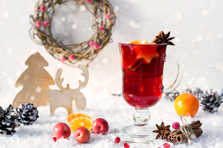 Wooden vintage rustic christmas decoration and hot mulled spiced red wine in glass mug Interior eco decor. Christmas or new year card Stock Photo