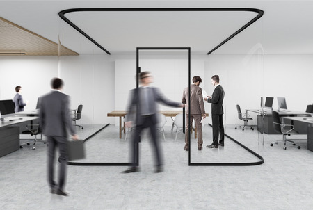 people working in an open office with a glass aquarium with
