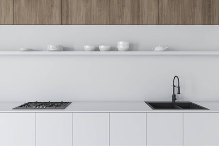 Close Up Of White Countertops With Built In Sink And Cooker