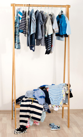 wardrobe of newbornkids toddlers babiesmany tshirtspants shirtsblouses shoes onesie hanging messy clothes thrown on a shelf kids messy closet g70 messy