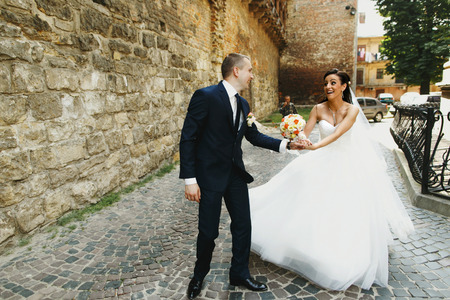 bride and groom run