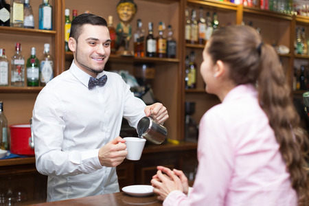 smiling bartender and barista working at bar focus on man stock bartender barista