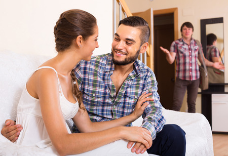 Stock Photo Upset Adult Discovering Cheating Girlfriend At Home Stock Photo Upset Adult Discovering Cheating Girlfriend At Home