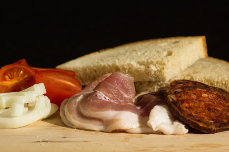 hungarian breakfast with home made kolbasz, tomato, onion and bread Stock Photo