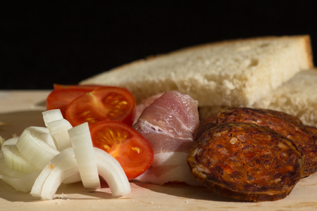 hungarian breakfast with home made kolbasz, tomato, onion and bread Stock Photo