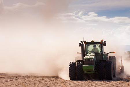 Close-up of a tractor plowing very dry and dusty farm land Stockfoto