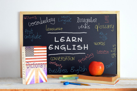 Blackboard in an English class. Some books and school stuff for studying English language in a classroom.
