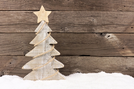 shabby chic wooden christmas tree with twine garland standing in snow against a rustic wood background - Rustic Wood Christmas Tree shabby chic wooden christmas tree with twine garland standing in snow against a rustic wood background - Rustic Wood Christmas Tree
