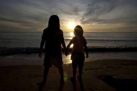 Two Sisters Holding Hands And Look Forward To The Sea In Silhouette - 450x300 - jpeg Two Sisters Holding Hands
