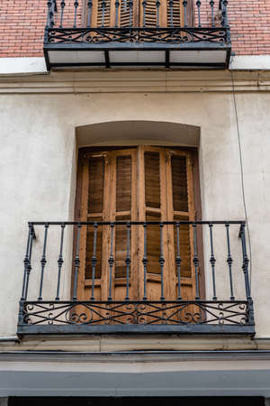 Low angle view of old cast iron balconies of old residential building in lavapies quarter in madrid Banco de Imagens