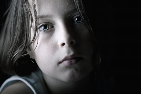 sad lonely: Low Key Shot of Sad Child