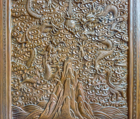 the wood engraving of the chinese dragons flying over the mountain