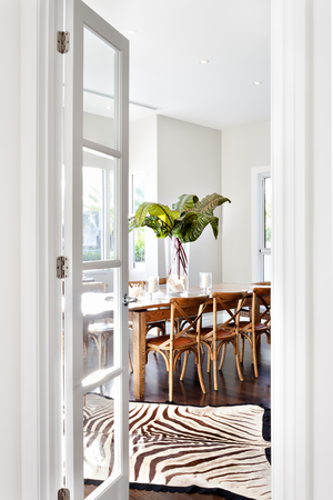Beautiful Wooden Dining Table In Drawing Room Of Luxury House Showing The Entrance With Door Beautiful Wooden Dining Table In Drawing Room Of Luxury House Showing The Entrance With Door