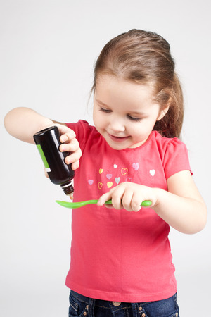 Cute Baby Girl Drinking Medicine Syrup Stock image Stock Photo Cute Baby Girl Drinking Medicine Syrup - Stock image Stock Photo - 50644652