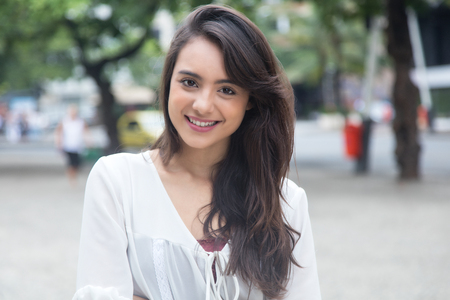 Beautiful woman with white blouse in a park