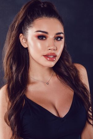 Portrait of a young woman with beautiful makeup and shiny lips.