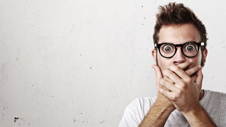 surprise: Portrait of a surprised young man wearing eyeglasses