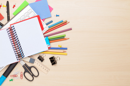 Blank notepad over school and office supplies on office table. Top view with copy space - 43705021