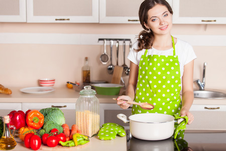 Young Woman Cooking in the kitchen. Healthy Food. Dieting Concept. Healthy Lifestyle. Cooking At Home. Prepare Food Stock Photo