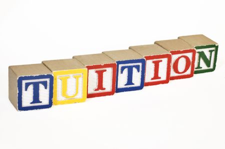 Wooden blocks laid out horizontally spelling out tuition Reklamní fotografie
