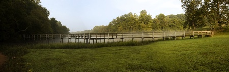 panarama shot of a wooden bridge at the edge of the Chattahoochee River