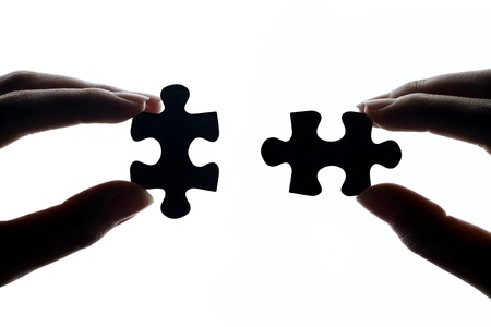 hands connecting jigsaw puzzle pieces stock photo picture and