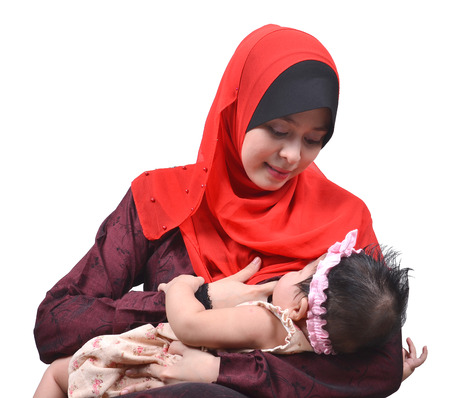 young asian muslim mother breastfeeding her cute baby girl isolated