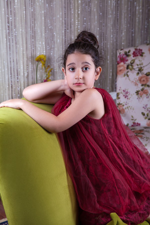 Cute Lovlely Middle Eastern Girl With Dark Red Dress And Collected Hair Posing And Liying On Cute Lovlely Middle Eastern Girl With Dark Red Dress And Collected Hair Posing And Liying On