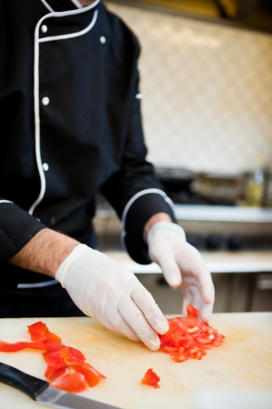 Midsection of chef preparing food in kitchen