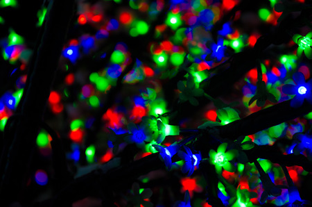 multicolored christmas light bulb leaves with blurred background