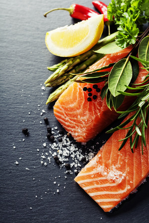 Délicieuse portion de filet de saumon frais avec des herbes aromatiques, des épices et des légumes - alimentation saine, alimentation ou concept de cuisson Photo stock