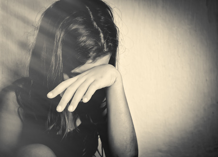 sad lonely: Monochrome portrait of a sad and lonely girl crying with a hand covering her face (with space for text) Stock Photo