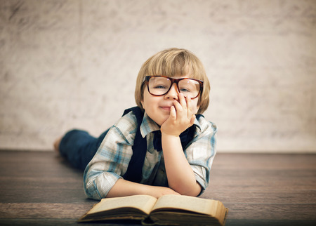 Clever boy reading a book