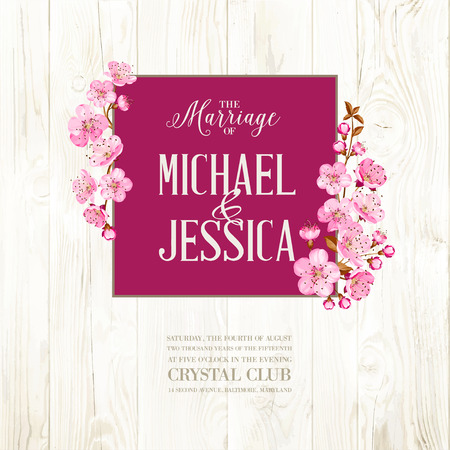 Wedding invitation on wooden backdrop. Spring flowers. Cherry blossom