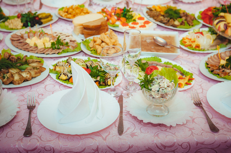 Decorated Table By The Window In Dining Room With Dishware And Tasty Food Decorated Table By The Window In Dining Room With Dishware And Tasty Food
