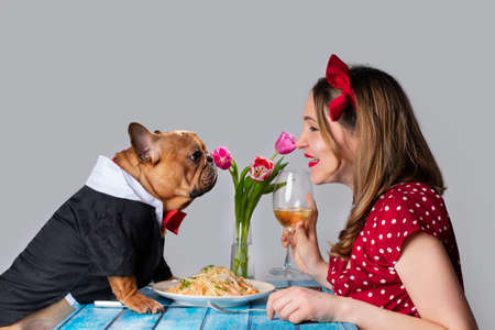 Young girl on romantic valentine's day date with her dog french bulldog Фото со стока