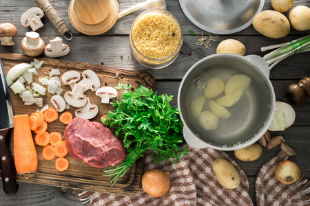Raw Ingredients For Cooking Soup On Wooden Table Top View Rustic Style Photo Raw Ingredients For Cooking Soup On Wooden Table Top View Rustic Style Photo