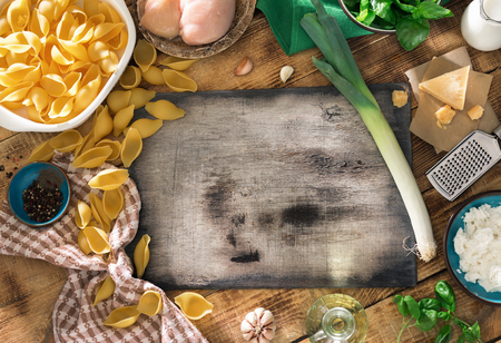 Kitchen Board With Ingredients For Cooking Italian Pasta On A Wooden Table Top View Kitchen Board With Ingredients For Cooking Italian Pasta On A Wooden Table Top View