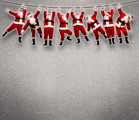 Christmas santa hanging on rope. funny concept background. Stock Photo